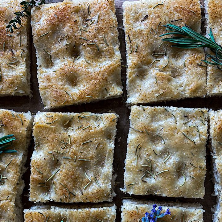 Simple Sourdough Focaccia Bread cut into squares topped with herbs