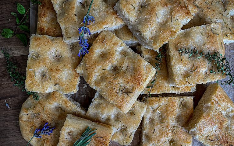 Simple Sourdough Focaccia Bread cut into squares with herbs