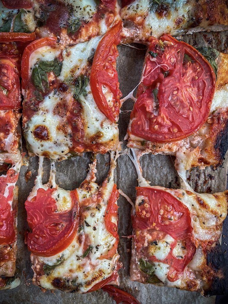 thick and crispy sourdough pizza crust with cheese and tomatoes