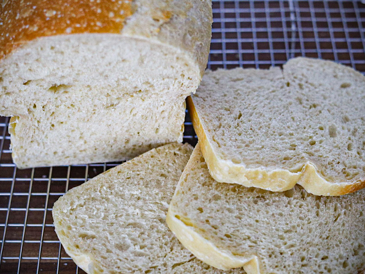 easy crustless sourdough sandwich bread on wire rack cut in 3 slices