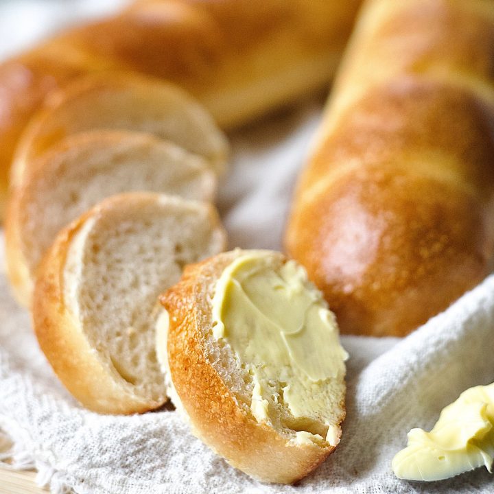 Simple sourdough french bread sliced with butter