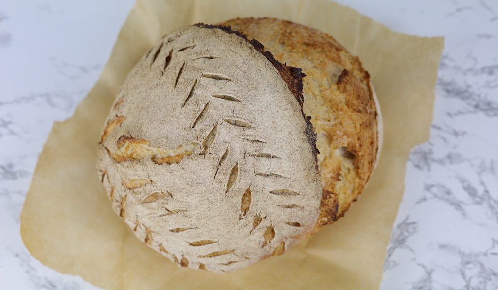 https://simpleisgourmet.com/wp-content/uploads/2021/03/Sourdough-loaf-from-top-with-deep-cut-1024x597.jpg