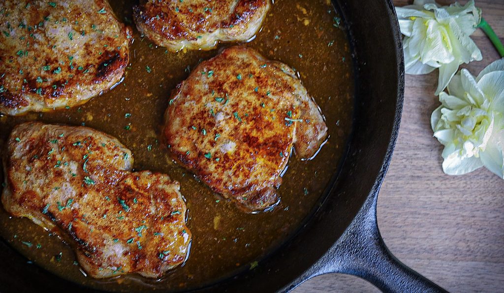 https://simpleisgourmet.com/wp-content/uploads/2021/05/Maple-glazed-pork-chops-in-skillet-with-flowers-1024x597.jpg