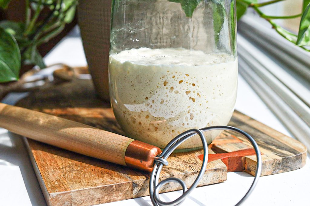 https://simpleisgourmet.com/wp-content/uploads/2023/03/I-have-a-sourdough-starter-now-what-Sourdough-starter-in-weck-jar-with-dough-hook-on-wood-board-1024x683.jpg