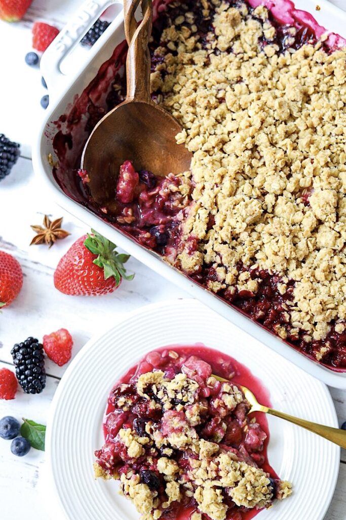 The Best Fruit Crisp Recipe on white plate with fruit simple is gourmet