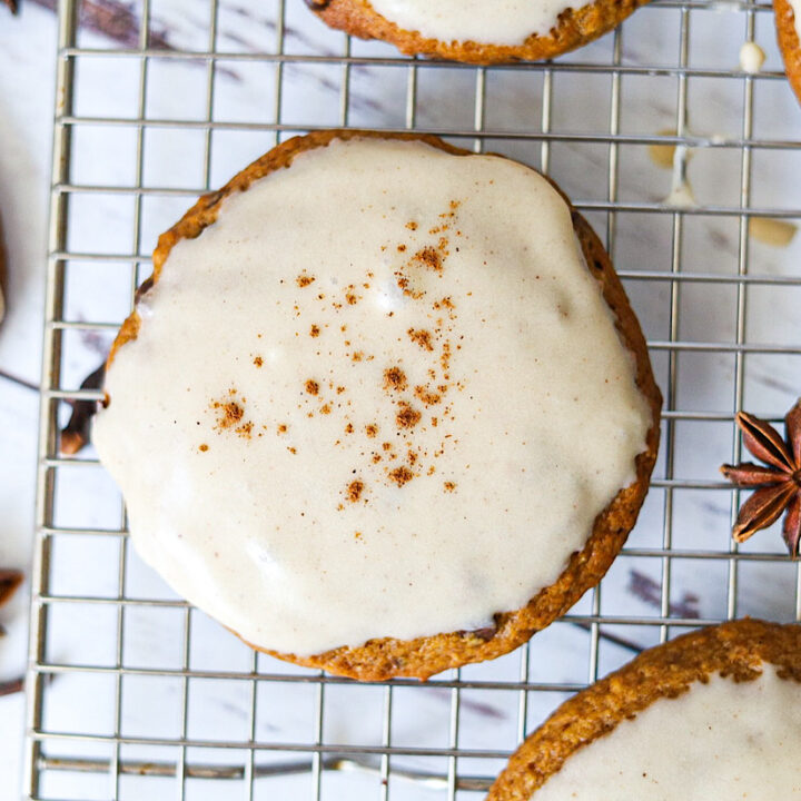The Best Pumpkin Sourdough Cookies with Maple Frosting on wire rack with spices simple is gourmet
