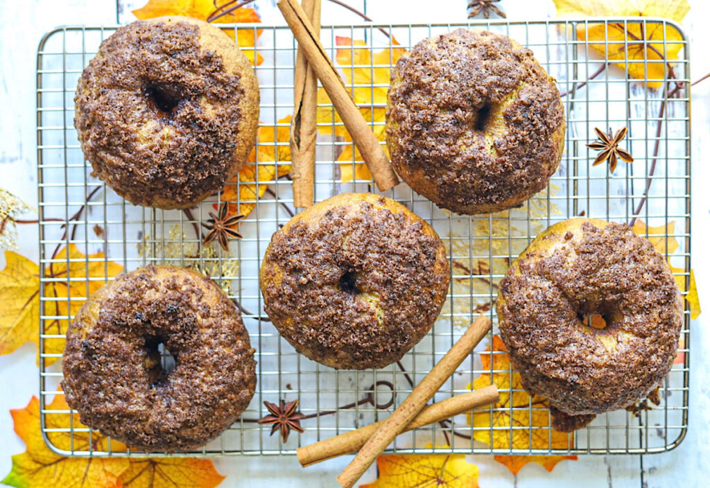 The Best Sourdough Pumpkin Cinnamon Crunch Bagels 1 on wire rack with fall leaves